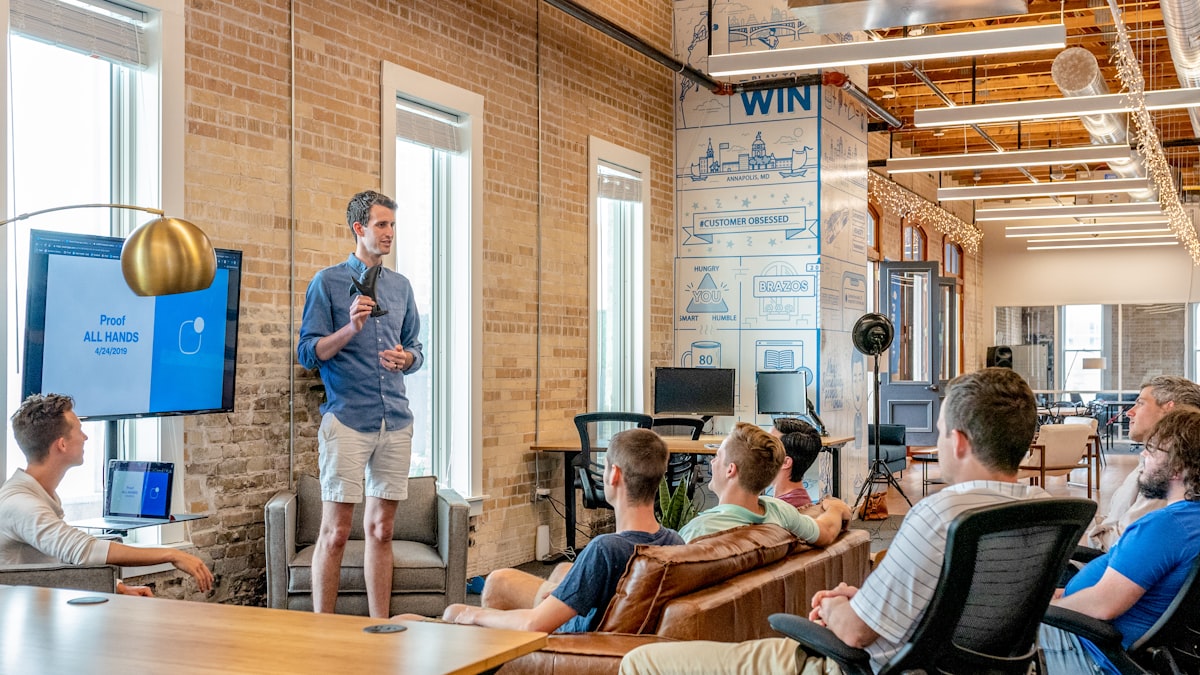 Business team discussing website design and project costs in a modern office